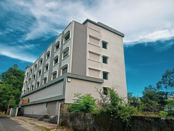 Low angle view of building by street against sky