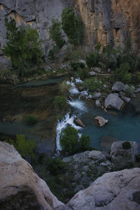 Scenic view of river stream amidst rocks