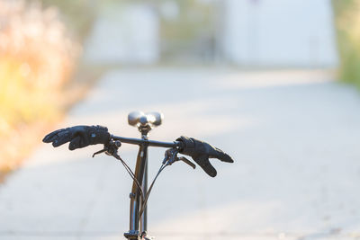Close-up of bicycle on street against blurred background