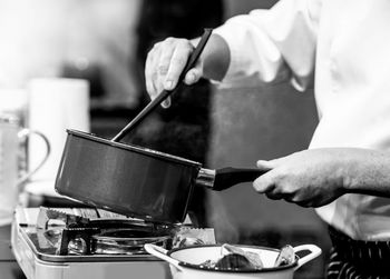 Midsection of man preparing food in kitchen