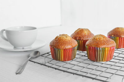 Close-up of cupcakes on table against white background