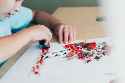 Close-up of girl drawing on table