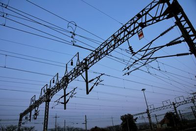 Low angle view of electricity pylon against sky