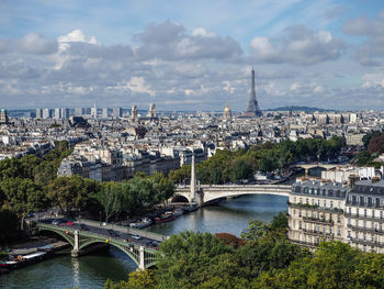 Aerial view of bridge over river against cloudy sky