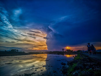 Scenic view of a lake against sky during sunset