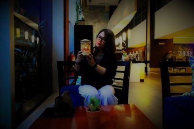 Young woman drinking glass at home