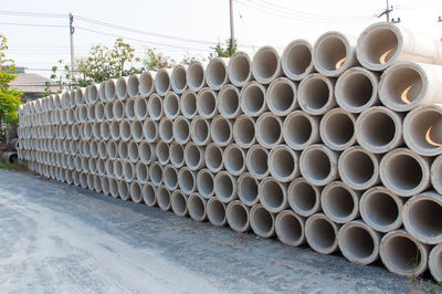 Stack of pipes on field