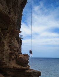 Scenic view of rock formation in sea against sky