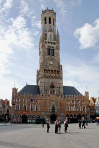 People in front of clock tower against sky