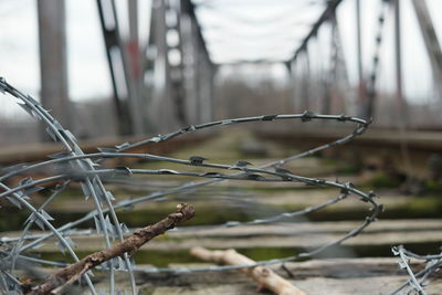 Close-up of barbed wire on railway bridge