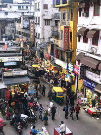 High angle view of people on street amidst buildings in city