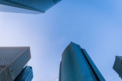 Low angle view of modern buildings against clear blue sky