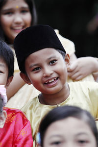 Smiling boy looking away while wearing black cap