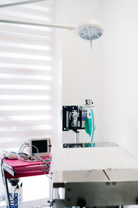 Interior of contemporary operating theater with metal table and gas anesthesia machine in veterinary hospital