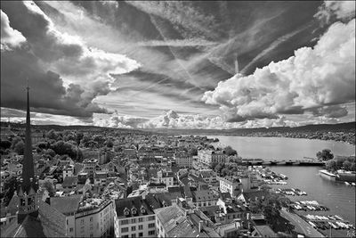 View of cityscape against cloudy sky