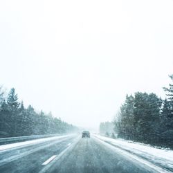 Road passing through snow covered landscape