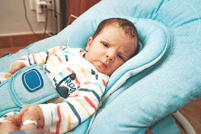 Cute baby girl on bed at home