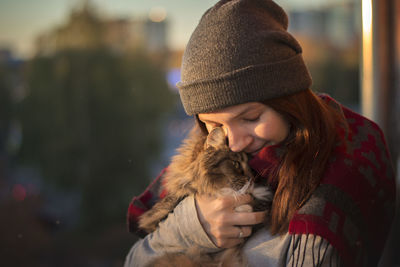 Young woman holding cat