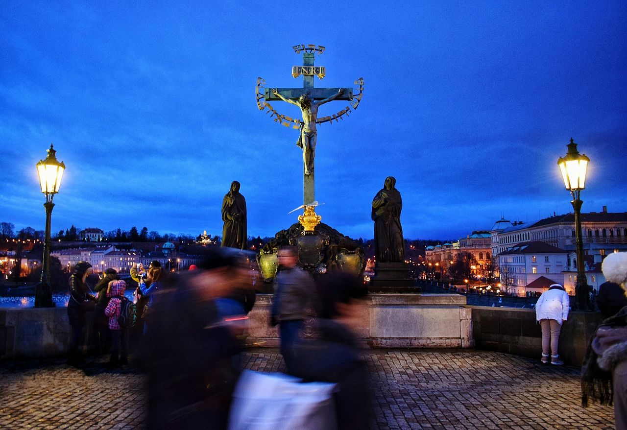 celebration, religion, large group of people, spirituality, illuminated, men, sky, statue, city, people, sculpture, night, adults only, city gate, outdoors, only men, adult