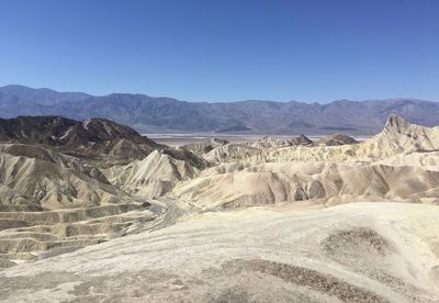 Scenic view of mountains against clear blue sky