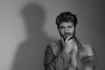 Portrait of young man against white background