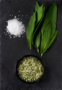 High angle view of leaves in bowl on table,ramson salt