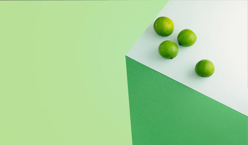 High angle view of green fruits on white background