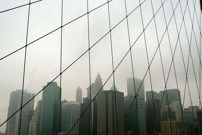 Modern buildings against sky seen from brooklyn bridge