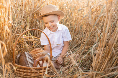 Portrait of cute baby boy standing in farm