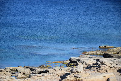 Scenic view of beach against blue sky