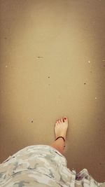 Low section of woman standing on tiled floor