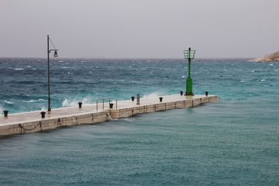 Pier over sea against clear sky