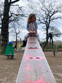 Low angle view of girl playing on playground
