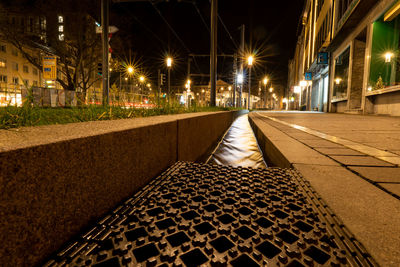 Surface level of street lights on footpath at night