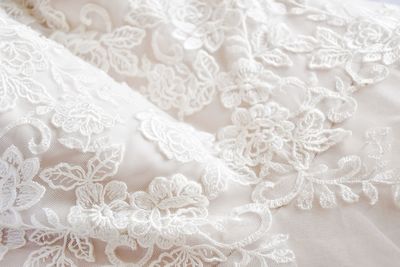 Full frame shot of white lace on a wedding dress 