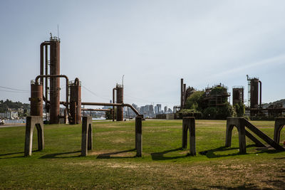 Built structure on field against sky in city