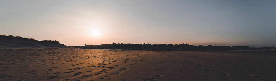 Scenic view of beach against sky during sunset