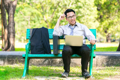 Man sitting on bench in park