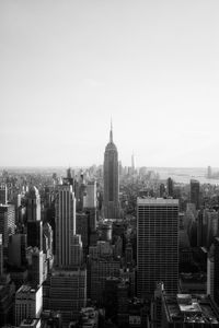 Aerial view of buildings in city against sky