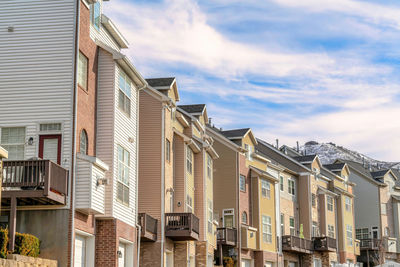 Low angle view of buildings against cloudy sky