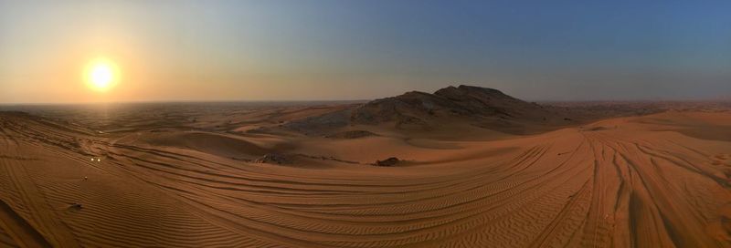 Scenic view of desert against sky during sunset