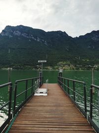 Pier amidst lake against sky