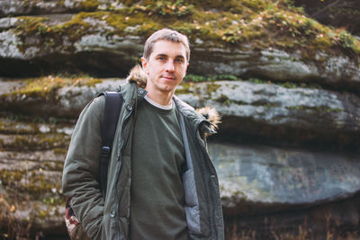 Portrait of young man standing outdoors