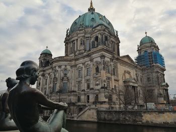 Low angle view of statue of building against sky