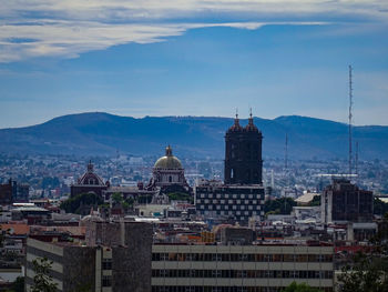 Buildings in city against sky