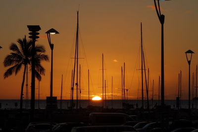 Silhouette of boats at harbor during sunset