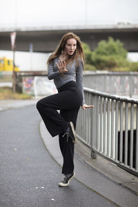 Young woman with dancing on street