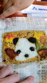 Cropped image of person holding dog