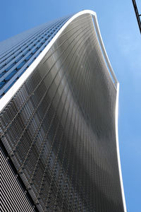 Low angle view of modern building against clear blue sky