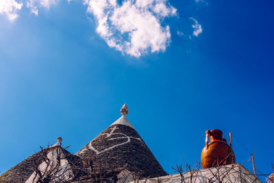 Low angle view of birds on rock against sky